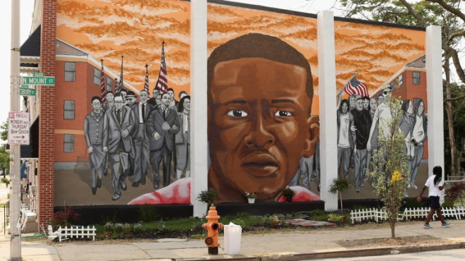 A mural memorializing Baltimore resident Freddie Gray adorns a wall near the place where he was tackled and arrested by police. The Baltimore Sun says it has acquired a copy of the unreleased government autopsy report in the case.
